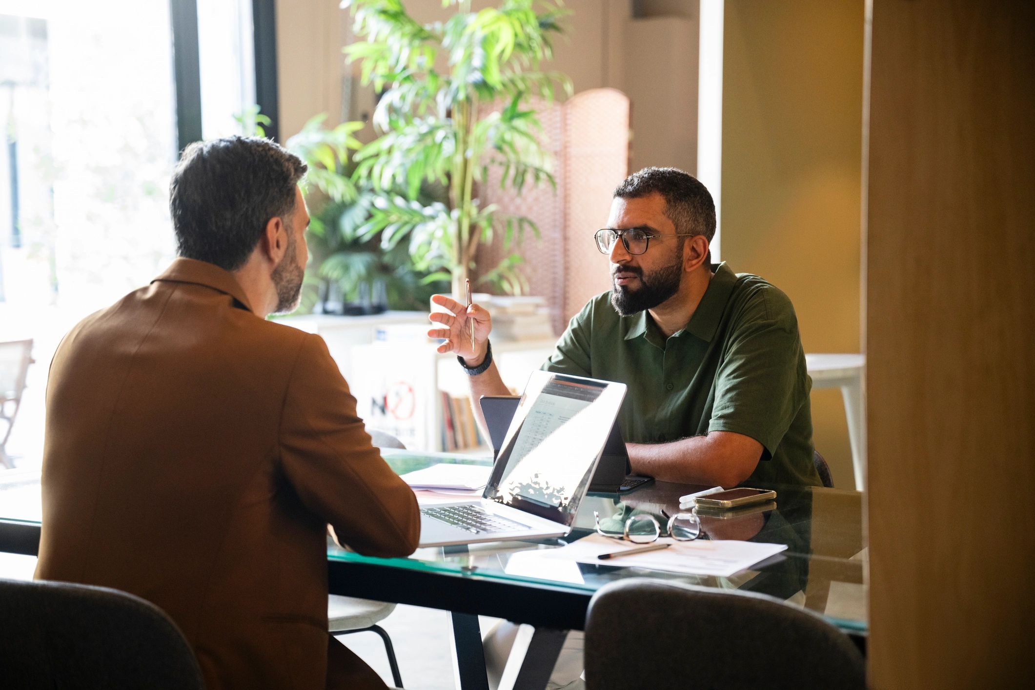 Professionals discussing a plan across a desk